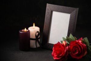 front view picture frame with red flowers candles dark surface